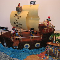 Pirate Ship With Treasure Chest Made this for my son's 6th Birthday. Inspired by many here on CC. Caramel cake (Thx to MacsMom!) filled with Milky Way filling. Iced...