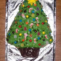 Christmas Tree Cake 2007 My first attempt at making a Christmas Tree Cake. My then 7 & 5 year old daughters picked out the stuff they wanted to decorate with...