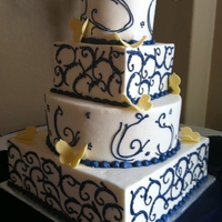 White-Blue--Yellow Wedding Cake White chocolate cake wit hraspberry filling.