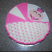 Baby Girl Basket 14" round, all butter cream, except baby's face which is fondant with black butter cream details.