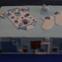 Blue Dot Onesie Cake I made this for my SIL's baby shower. Coordinated to match the invitations, which I also made. Pacifier was made of gumpaste.