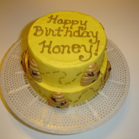 Happy Birthday Honey 5in and 6in round iced in buttercream. Beehives are chocolate molds in peanut butter and chocolate flavor.