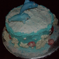 Dolphins At Play Under the sea with fondant dolphins jumping on top. I also used white chocolate to make the coral and shells.