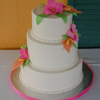 Tropical Flower Wedding Cake Choco cake with buttercreme icing and gumpaste flowers.