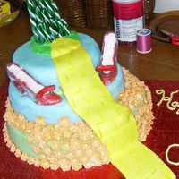 Wizard Of Oz I loved making this cake! Three tiered cake, covered in MMF. The ruby red slippers are wedding decorations stuffed with MMF and red...