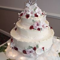 Wedding Cake With Lilies Gumpaste flowers: Lilies, calla lilies, and astralmeria with buttercream frosting and fondant lace.