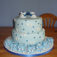 Converse Christening Hi, an 8 and 10 inch cake sitting on a 16inch board. My first attempt at gumpaste baby converse (thank you for the templates...