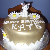 Cat Cake 8 inch, fondant made gold with lustre dust. The cat is supposed to have one eye it was made to look like her cat.