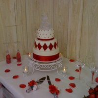 Wedding Cake Three layer white cake with fondant covering. Designed with fondant colored pearls, diamonds, and and ribbon