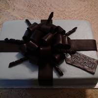 Present For Dad chocolate cake with butter cream icing and fondant bow