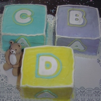 Baby Blocks Buttercream covered pound cakes. Letters are gumpaste. Teddybear is gumpaste.