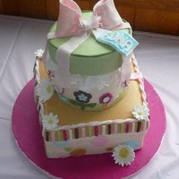 Baby Fiona Baby Fiona Gift Box Cake has 9" square and 6" round lemon cake with raspberry filling. Gum paste tissue paper and flowers. Iced...