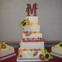Fall Wedding Cake 14,12,10,8,6in square cakes covered in buttercream, and 2 10 in satellite cakes. This is my first paid wedding cake. The leaves and flowers...