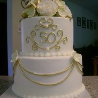 Golden Anniversary 6 and 8 in buttercream, gumpaste roses, fondant accents. I took Sugarshack's "50" design with her permission. TFL Jen