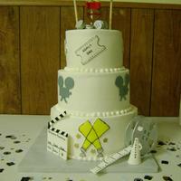 Future Film Director Cake 10, 8, 6 in tiers. Buttercream icing, gumpaste details (except the chair...groan) and fondant accents. TFL Jen