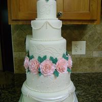 Wedding The tiers are 12, 10, 8, 6, and 4 all covered in fondant. Gumpaste roses and fondant/gumpaste mix pearls. TFL Jen
