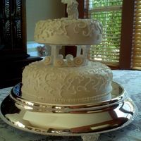 2-Tier Wedding Cake Simple, white wedding cake. The bride and groom picked out the topper, the rest was a simple design.