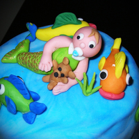 Mermaid Baby For an ocean themed baby shower my second fondant cake. The cake was 2-tiered, with seashells and fish covering the sides. All made from...