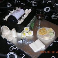 Wine Bottle Cake The cake is a layered white cake with white chocolate ganache and raspberry coulis. The box is dark Callebault chocolate. The cheese and...