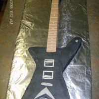 Guitar Cake- Replica A friend wanted me to make a replica of her son's guitar. I think it turned out pretty good. It is carved from a sheet cake with a...