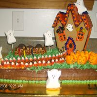 Halloween Cake I made this cake for my son's 4th birthday. I used a haunted house gingerbread set, green coconut for grass, milano cookies for...