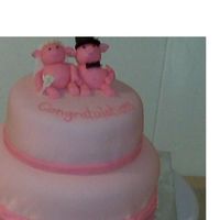 Pink Pig Wedding 8 and 6" tiered cake covered with fondant with fondant bride and groom pigs.