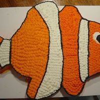 Andrew's Nemo Cake 6- 12" cake rounds carved and then pieced together to make Nemo fish shape. Buttercream icing colored with red and yellow food...