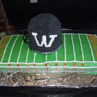 Football Field And 3D Helmet Cake The field is made from 2 sheet cakes put together and iced with buttercream. The helmet is 5 or 6 round layers stacked and then carved some...