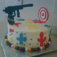 Paintball paintball gun and target are fondant,gumballs and buttercream splatters