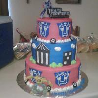 Transformers2 iced in buttercream,fondant accents,transformer toys