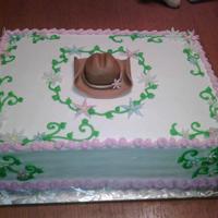 Cowgirl cowgirl hat and flowers were made from fondant,iced in buttercream