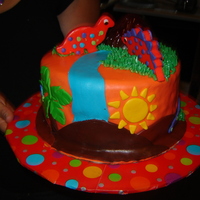 Dinosaur Birthday Cake This was my second dinosaur cake and my second paid order. It is a chocolate cake with chocolate ganache in the middle and covered in MMF....