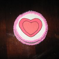 Small Hearts This is a small 6" round cake for the 1 year old birthday girl to have her own cake to play in. Used cookie cutters for the heart...