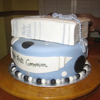 First Communion Cake Two tier cake with fondant covered Bible and fondant Rosary.
