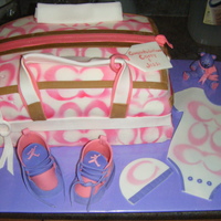 Coach Diaper Bag Coach onsie, baby hat, Jordans sneakers, and a teddy! Lemon cake on top, Chocolate on bottom