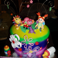 Lamaze Toys Christening Cake Colorful christening cake with Lamaze toys inspired gum paste figures