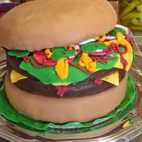 Cheesburger This hamburger was for a 4th of July celebration and had to feed about 100 people. All cake parts are covered in fondant and condiments are...