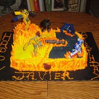Transformers Butter sheet cake with buttercreme icing.The flames are buttercreme and the tranformers are toys.