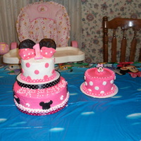 Minnie Mouse And Smash Cake yellow cake with buttercreme icing and fondant accents. Minnie Mouse is a toy