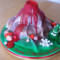 1253254268.jpg T-Rex dinosaur and erupting volcano cake