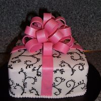 Birthday Gift Vanilla cake with chocolate fudge filling, covered with bc, scroll work in bc, fondant bow