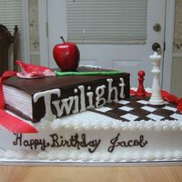 Twilight Cake BC iced book & cake, book cover & all items are made of candy clay except the apple it's fake. Twilight lettering was white...