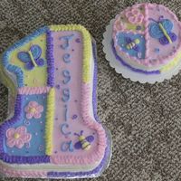 Little Girl's First Birthday In Pastels Main birthday cake and a smash cake. Although she only put her finger in the frosting a ltitle.