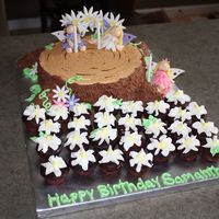 Fairies In The Forest 10" cake for the stump with mini cupcakes for the roots covered in chocolate b/c. Fairies and accents are all fondant. Thank you to CC...