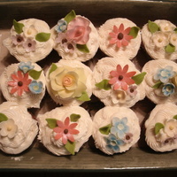 Spring Flower Cupcakes All chocolate cupcakes with cream cheese frosting. Flowers are all out of fondant. Some painted with color.