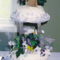 Traditional 3 Tier Wedding Cake This was a traditional white wedding cake, covered in butter cream icing and fondant. Adorned with lavender gumpaste flowers, royal icing...