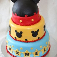 Mickey Mouse Yellow cake with dulce de leche filling (YUM!) and cream cheese icing! All fondant- name was piped on stars with royal icing.