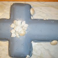 Baptism Cake White covered in mmf. Royal icing drop flowers and white chocolare shells dusted with pearl dust.