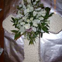 Baptism Cross Cake This cake is almond pound cake with raspberry buttecream. It is decorated with bc and fresh flowers.