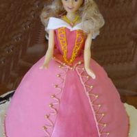 Aurora Cake This cake was done for a young girls birthday. Aurora sits atop a 1/2 sheet decorate with pink flowers. She is fondant covered, with the...